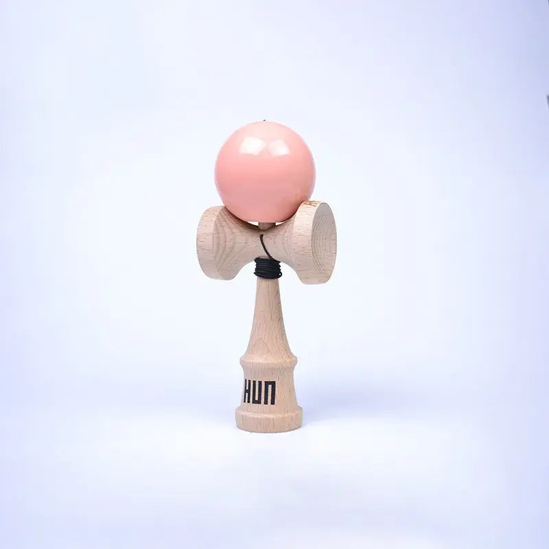 HUN Kendama Kylin Model with a glossy pink ball, natural wood handle, and light background.