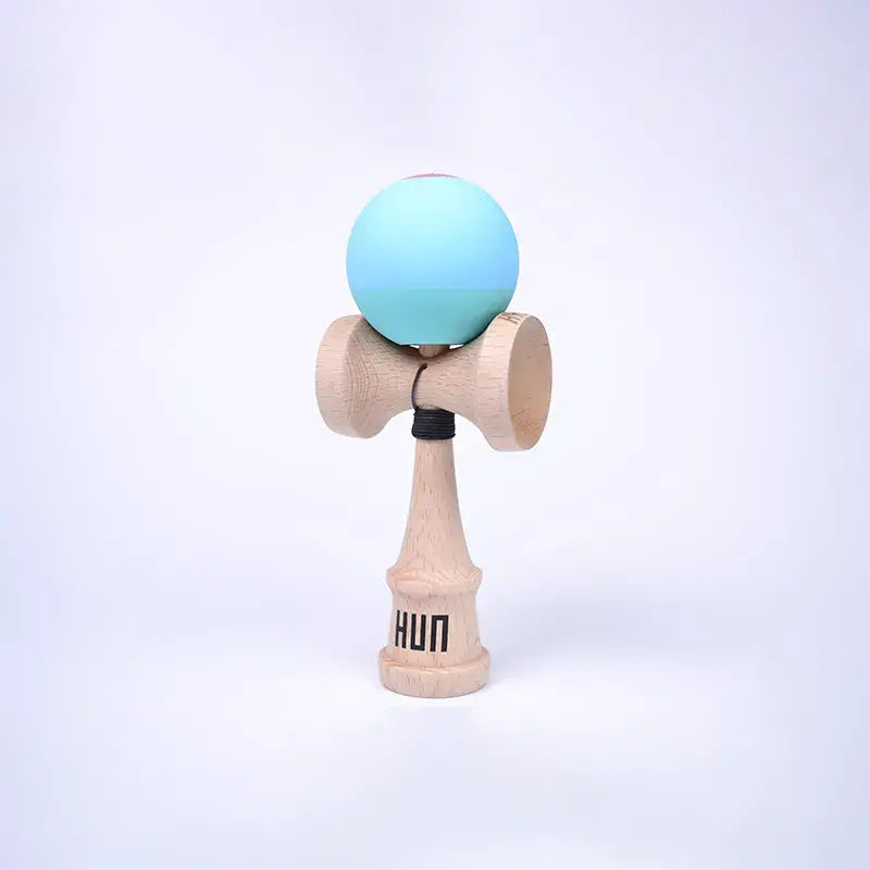 HUN Kendama Kylin Model with a pastel blue gradient ball, natural wood handle, and light background.