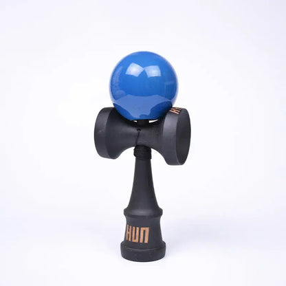 HUN kendama with a glossy blue ball, black wooden handle, and light background.