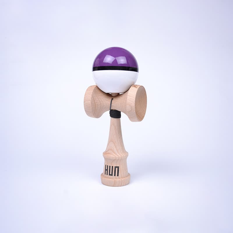 HUN Kendama Kylin Model with a glossy purple and white ball, black stripe detail, natural wood handle, and light background.