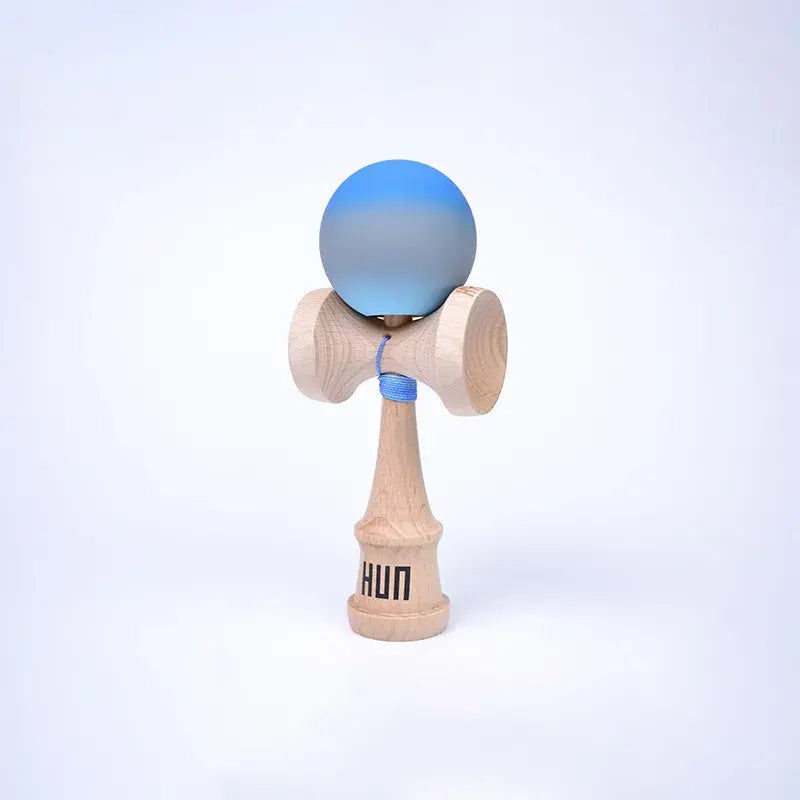 HUN Kendama Kylin Model with a blue and gray gradient ball, natural wood handle, and light background.