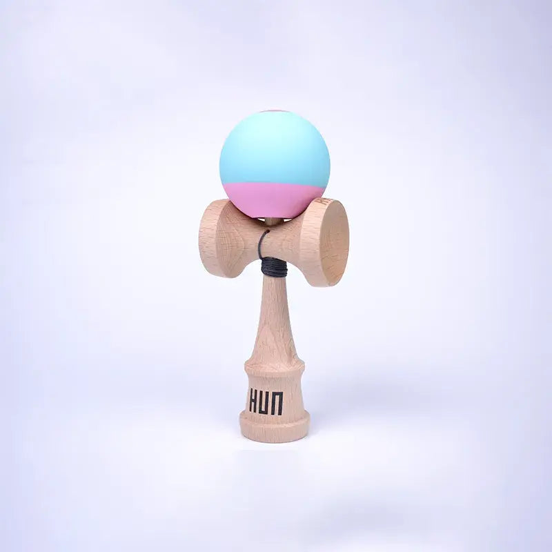 HUN Kendama Kylin Model with a pastel blue and pink ball, natural wood handle, and light background.