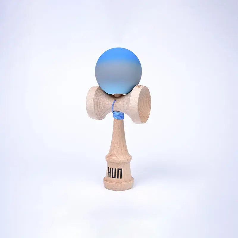 HUN Kendama Kylin Model with a blue and gray gradient ball, natural wood handle, and light background.