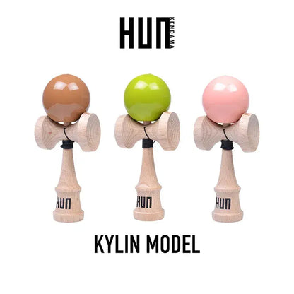 HUN Kendama Kylin Model product image featuring three wooden kendamas with glossy brown, lime green, and pink balls on a light gray background.