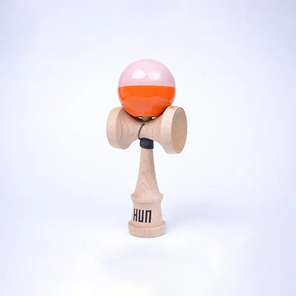 HUN Kendama Kylin Model with a glossy light pink and bright orange ball, natural wood handle, and light background.