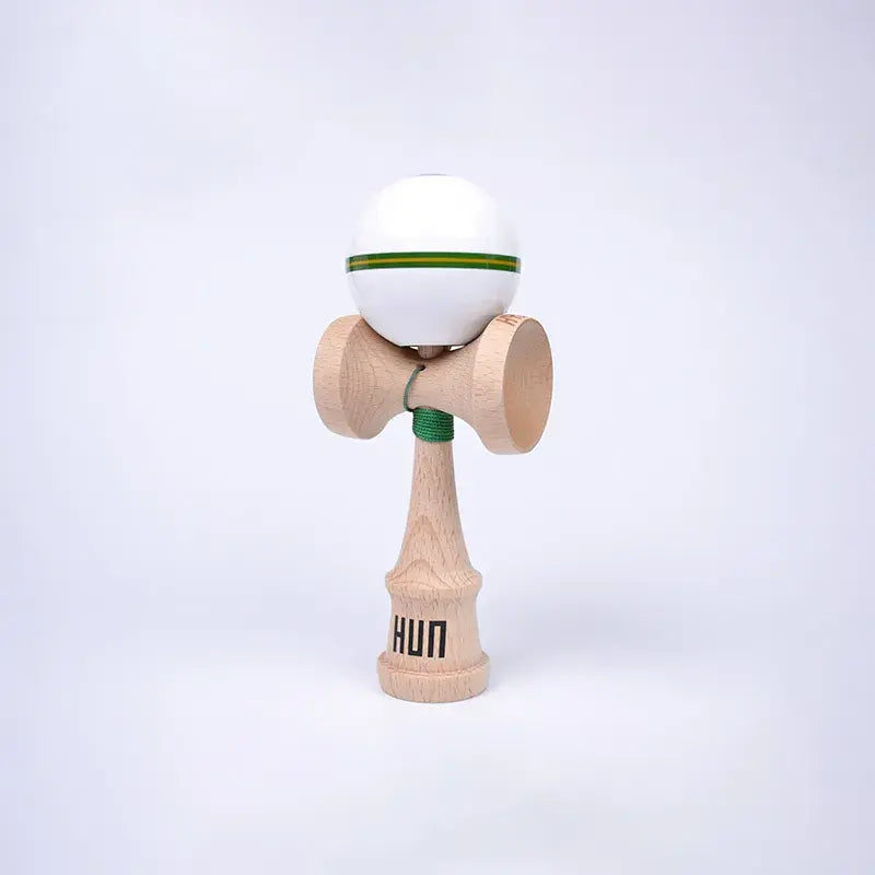HUN Kendama Kylin Model with a glossy white ball, green and yellow stripe detail, natural wood handle, and light background.