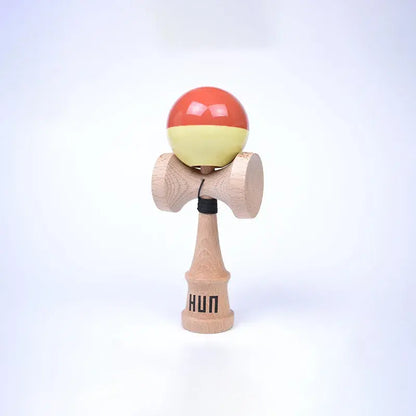 HUN Kendama Kylin Model with a glossy coral and pale yellow ball, natural wood handle, and light background.