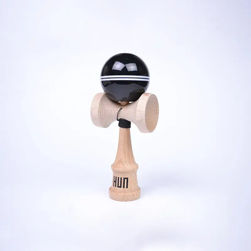 HUN Kendama Kylin Model with a glossy black ball, double white stripe detail, natural wood handle, and light background.