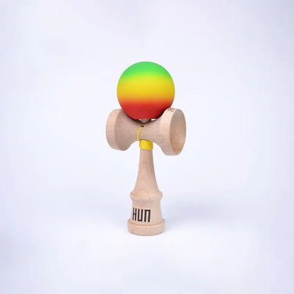 HUN Kendama Kylin Model with a green, yellow, and red gradient ball, natural wood handle, and light background.
