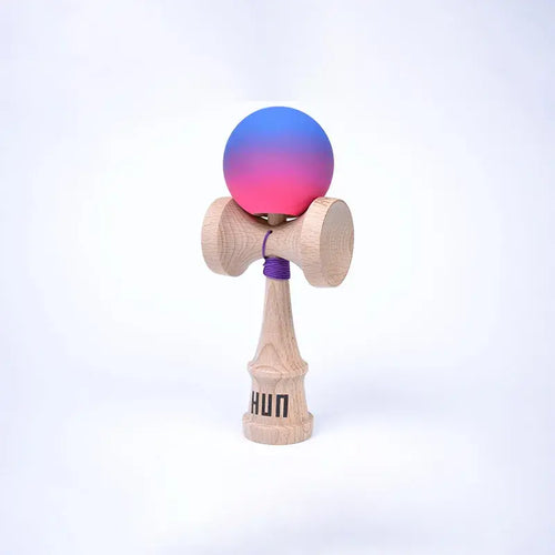 HUN Kendama Kylin Model with a pink and blue gradient ball, natural wood handle, and light background.