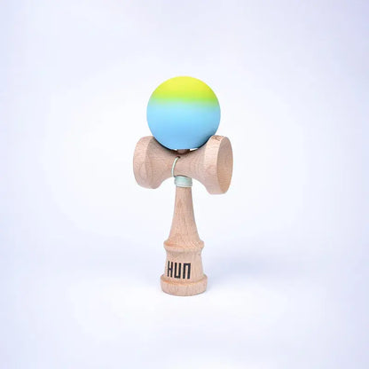 HUN Kendama Kylin Model with a yellow and blue gradient ball, natural wood handle, and light background.