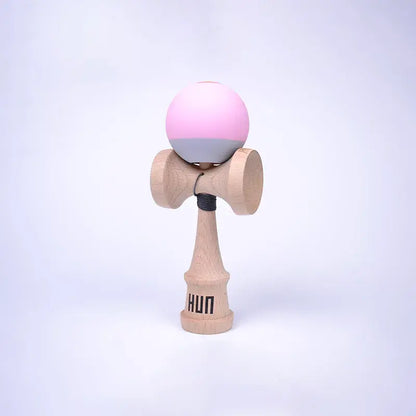 HUN Kendama Kylin Model with a pastel pink and gray ball, natural wood handle, and light background.