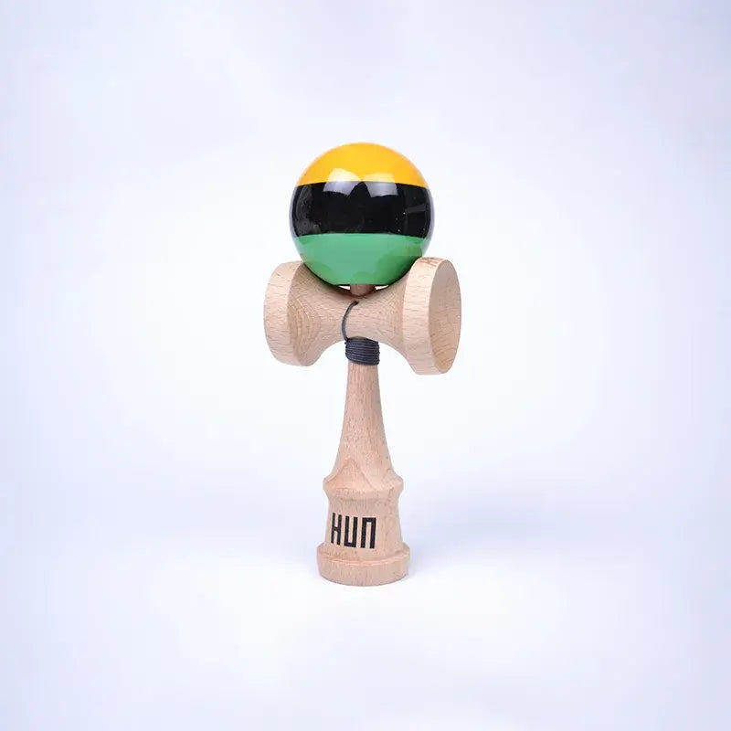 HUN Kendama Kylin Model with a glossy yellow, black, and mint green striped ball, natural wood handle, and light background.